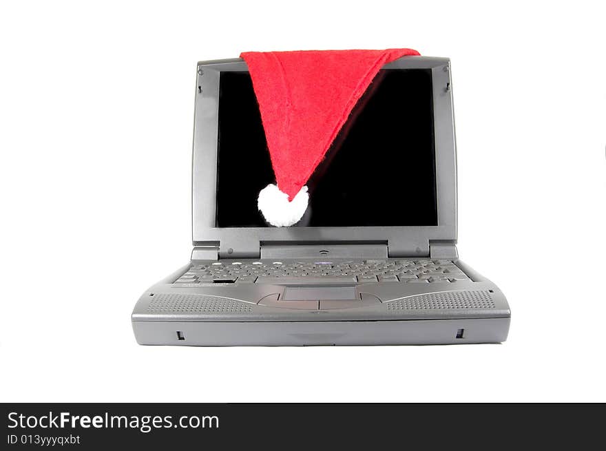 Santa's hat on a laptop isolated on white. Santa's hat on a laptop isolated on white