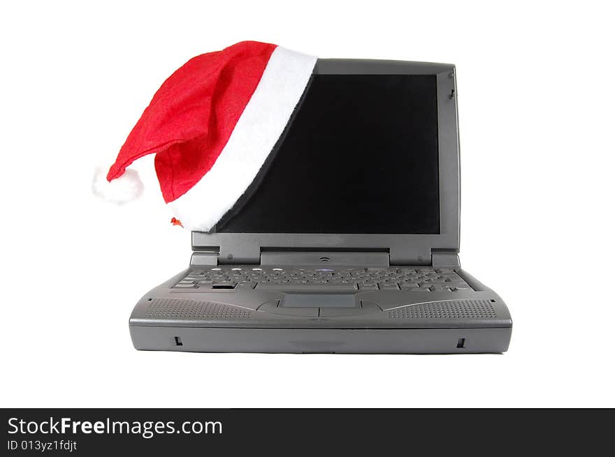 Santa's red hat on a laptop isolated on white. Santa's red hat on a laptop isolated on white