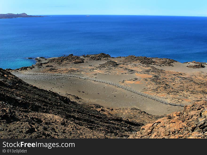 Wooden steps traverse the barren landscape of the Galapagos Islands. Wooden steps traverse the barren landscape of the Galapagos Islands