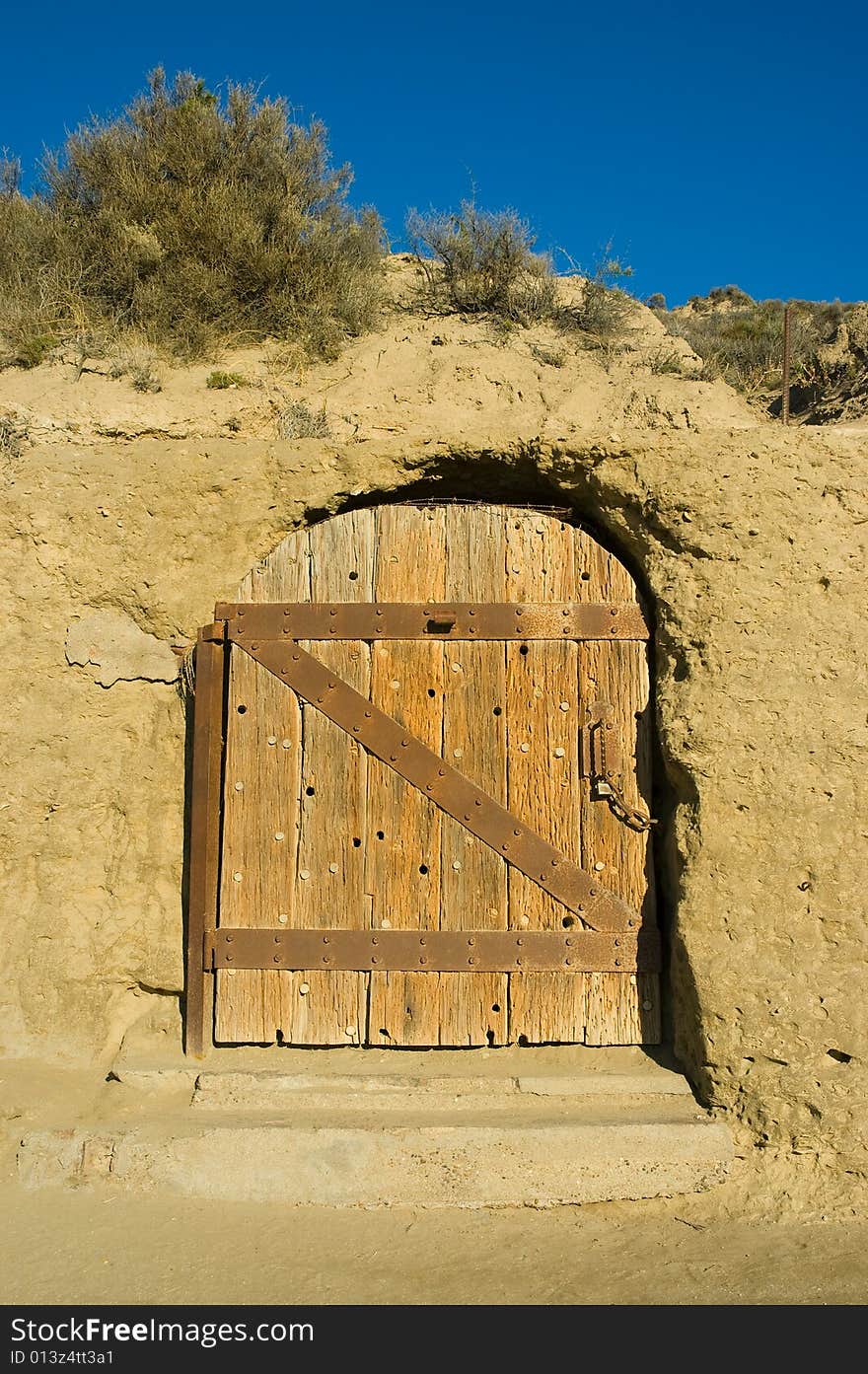 Antique door of a house carved in a cliff in patagonia, argentina.