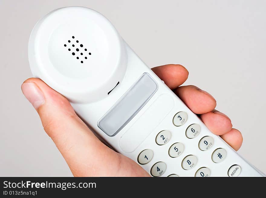 An image of telephone in mans hand. An image of telephone in mans hand