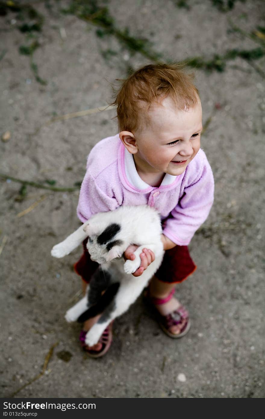 The happy young girl with a cat in her arms. The happy young girl with a cat in her arms