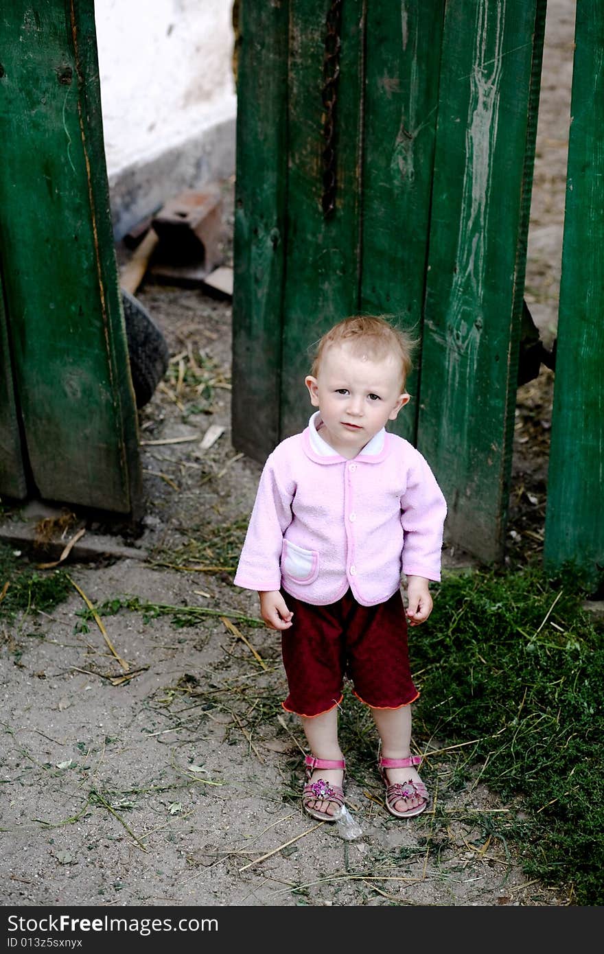 Smal girl near fence