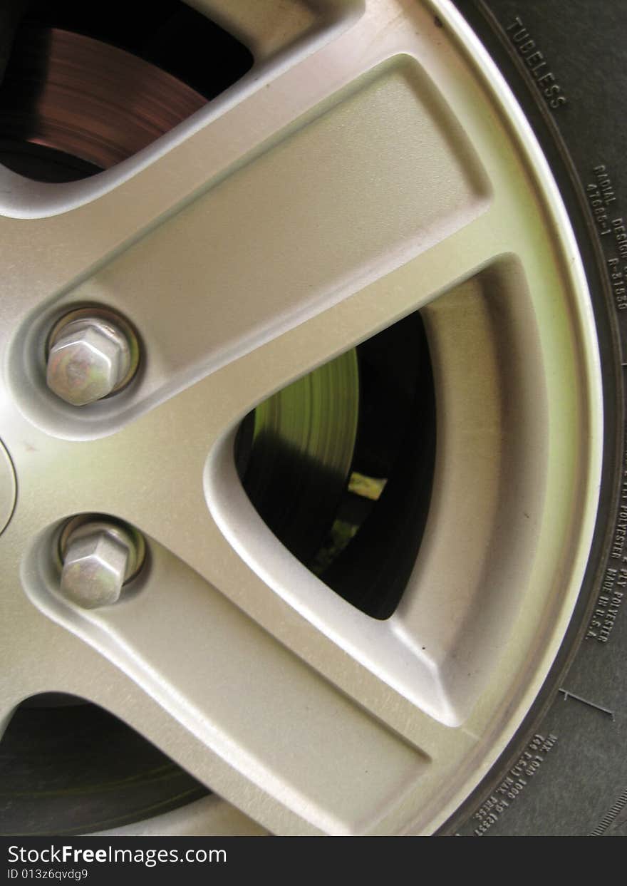 Shot of half of car wheel/ tire and view of brake disc. Shot of half of car wheel/ tire and view of brake disc