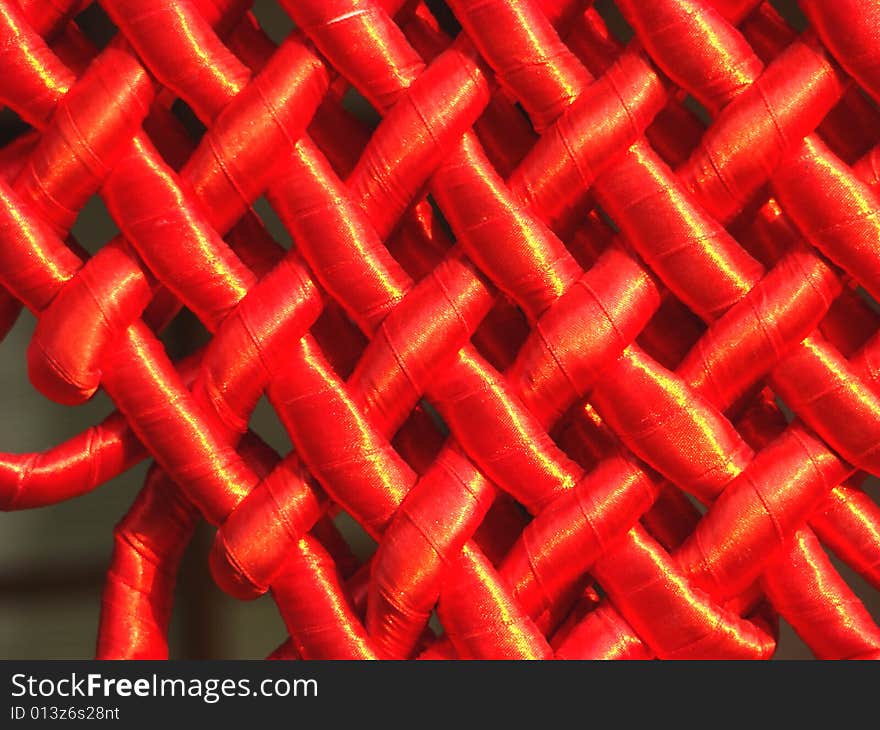 Grid weaved from a red satiny tape