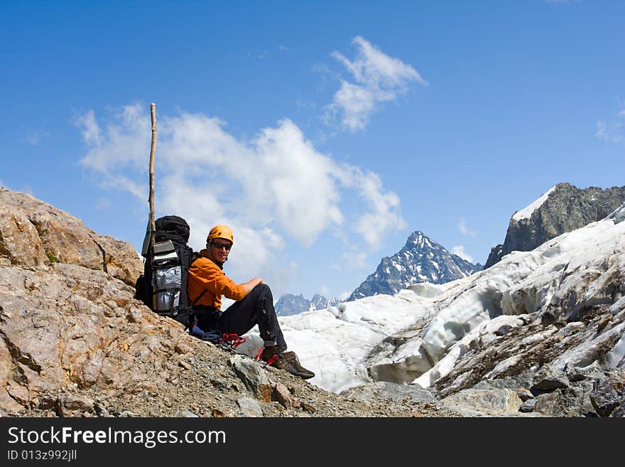 Tourist Sitting On Cliff