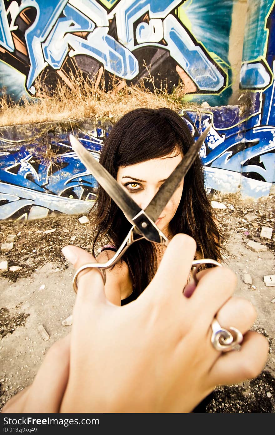 Young goth styled woman holding scissors for. Young goth styled woman holding scissors for...