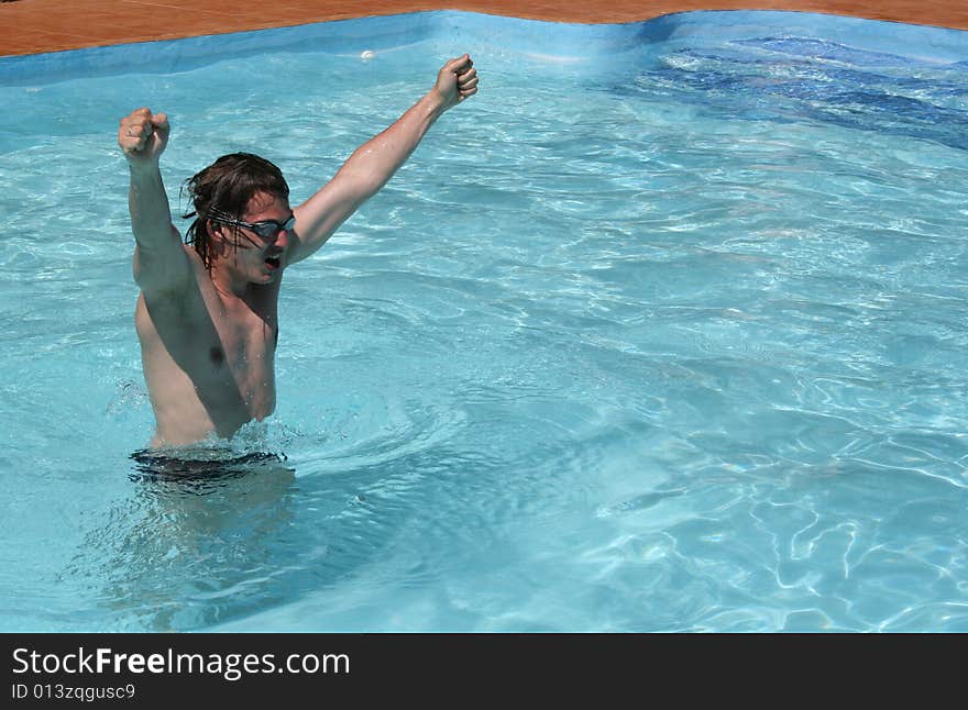 Young wan in the pool happy becourse of his succes. Young wan in the pool happy becourse of his succes