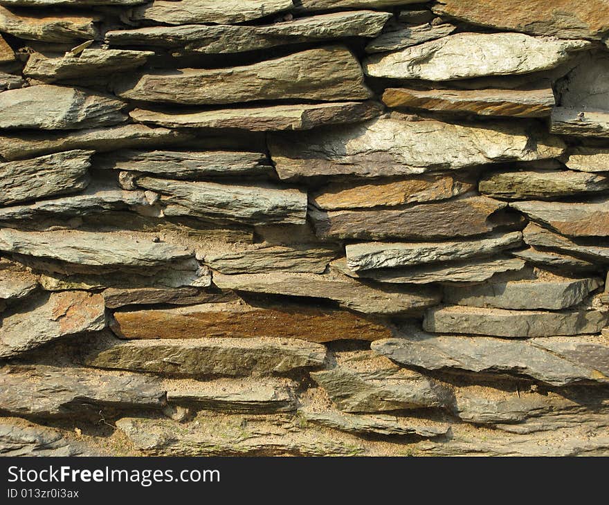 Fragment of rustic stone wall surface texture. Fragment of rustic stone wall surface texture