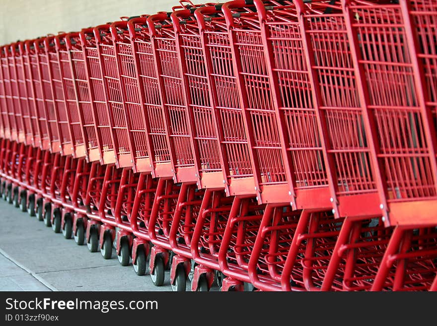 Row of red metal shopping carts