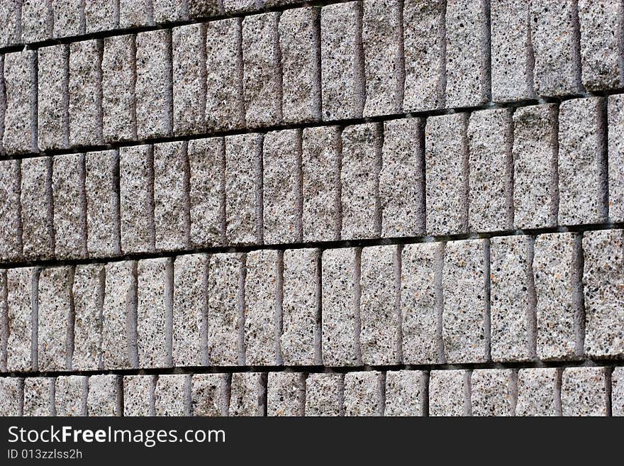 A block wall of cut stone blocks. A block wall of cut stone blocks