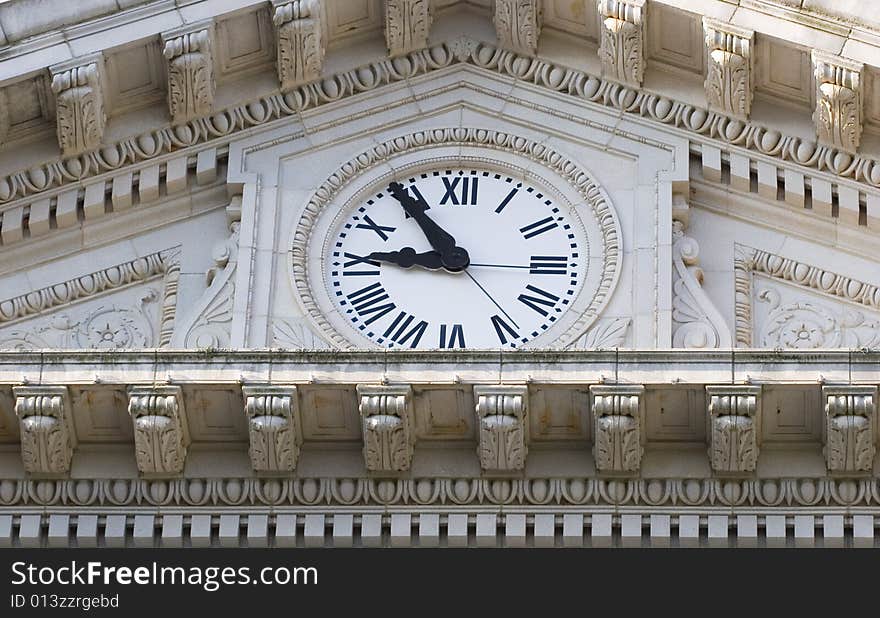 An old clock on the granite face of a courthouse. An old clock on the granite face of a courthouse