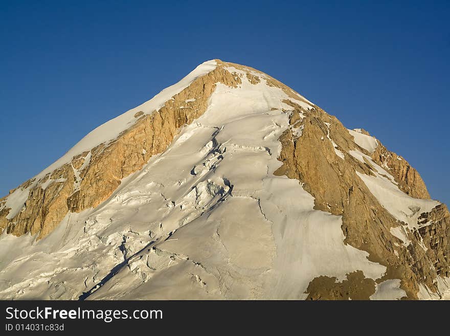 High rocky mountain peak with glacier