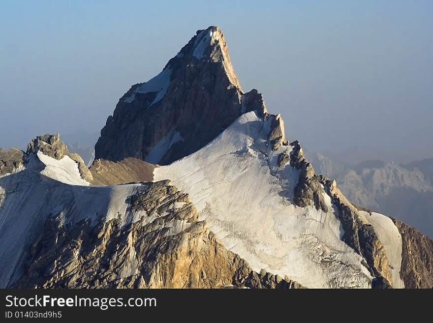 Forbidding cliff with the glacier in the evening