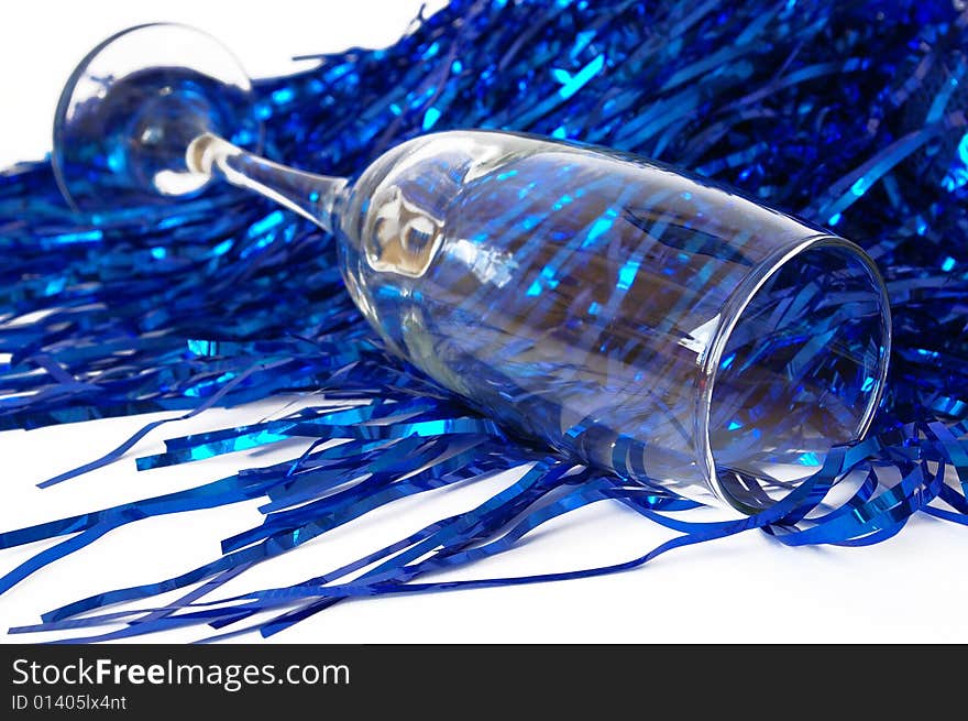 Champagne goblet and a dark blue tinsel