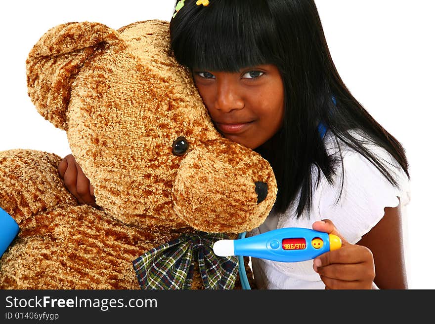 Beautiful Indian girl playing nurse to giant teddy bear. Beautiful Indian girl playing nurse to giant teddy bear.