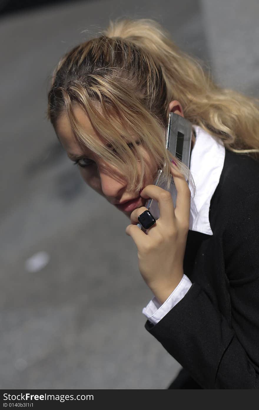 Pretty businesswomen talking on the phone waiting for a taxi