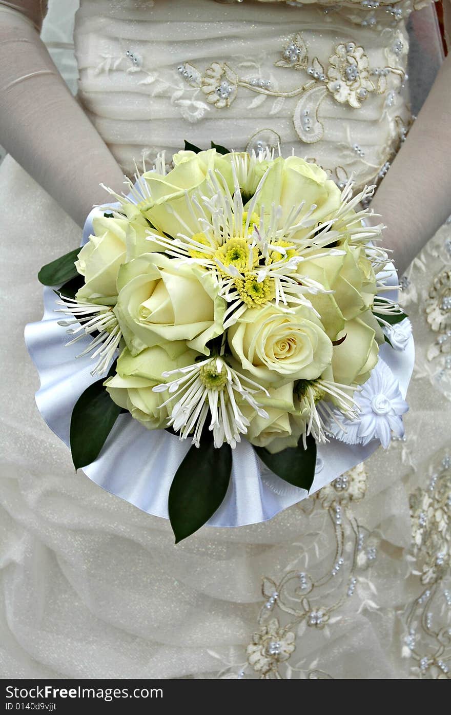 Half body portrait of bride in traditional white wedding dress holding yellow bouquet of roses. Half body portrait of bride in traditional white wedding dress holding yellow bouquet of roses.