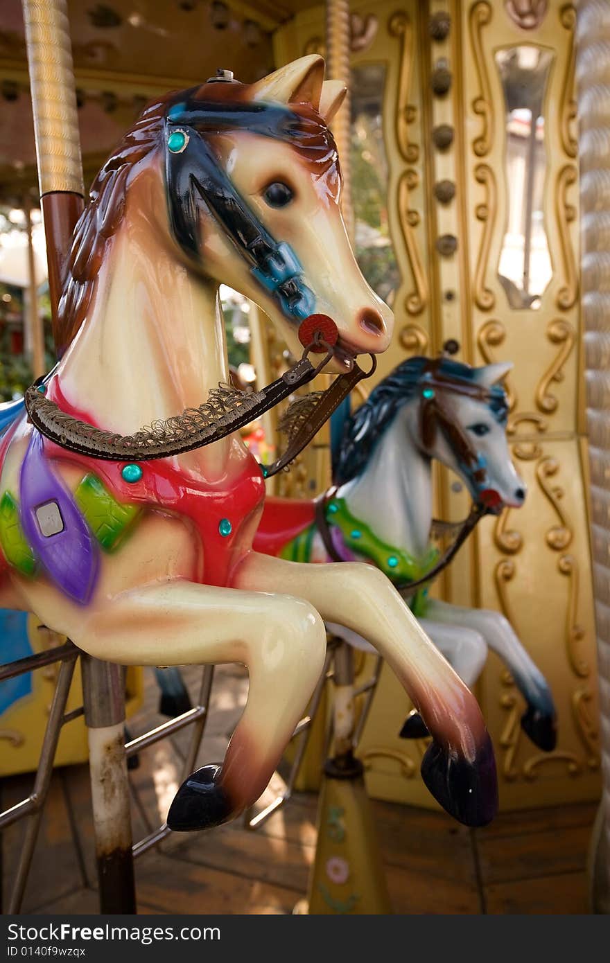 Multi-coloured horsies on a roundabout unsuccessfully try to catch up each other. Multi-coloured horsies on a roundabout unsuccessfully try to catch up each other