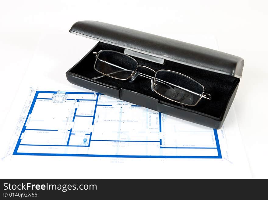 Blueprint for a house and eyeglasses