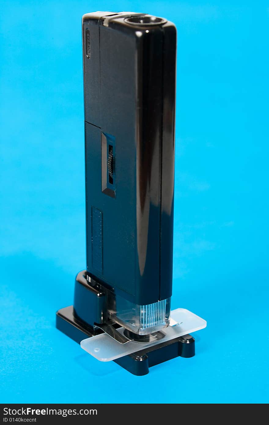 Pocket microscope on blue background