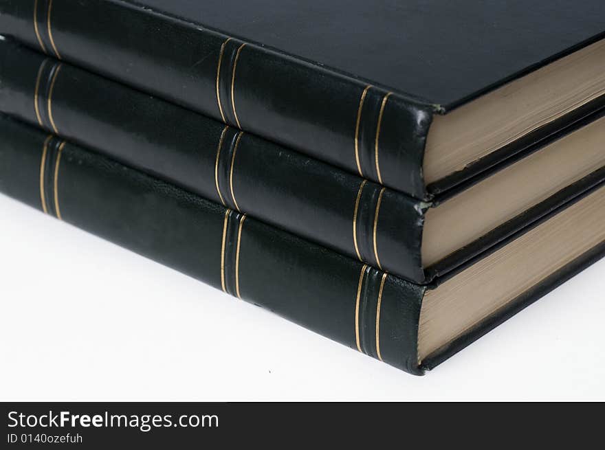 A stack of leather bound hard cover books