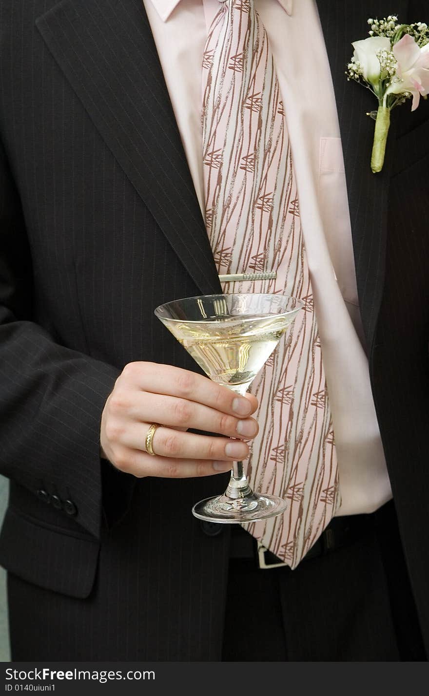 Wine glass in a hand of bridegroom