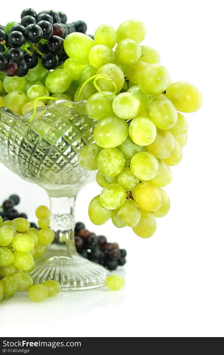 Cluster of green and blue grape isolated on white background