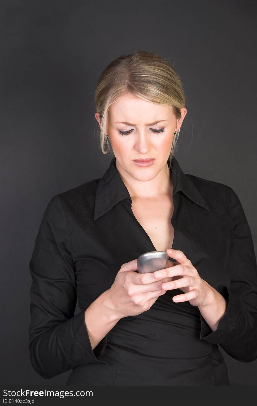 Beautiful blond businesswoman holding a cordless telephone. Beautiful blond businesswoman holding a cordless telephone