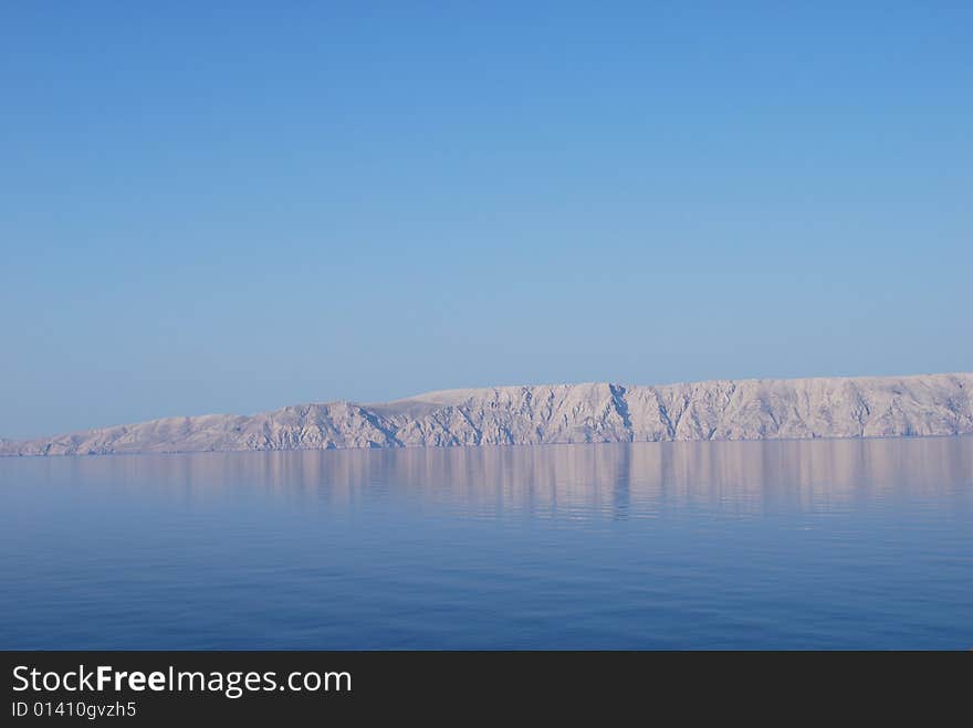 Early morning sea reflection from Smokvice village on island Krk, Croatia. Early morning sea reflection from Smokvice village on island Krk, Croatia