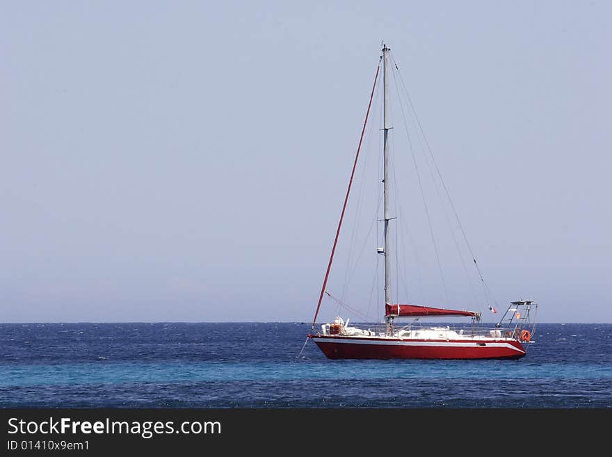 A modern sailing yacht at anchor in bay Corsica