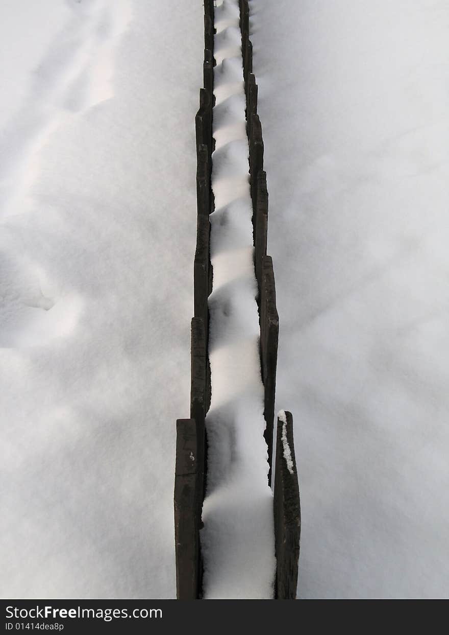 Wooden fence in the snow