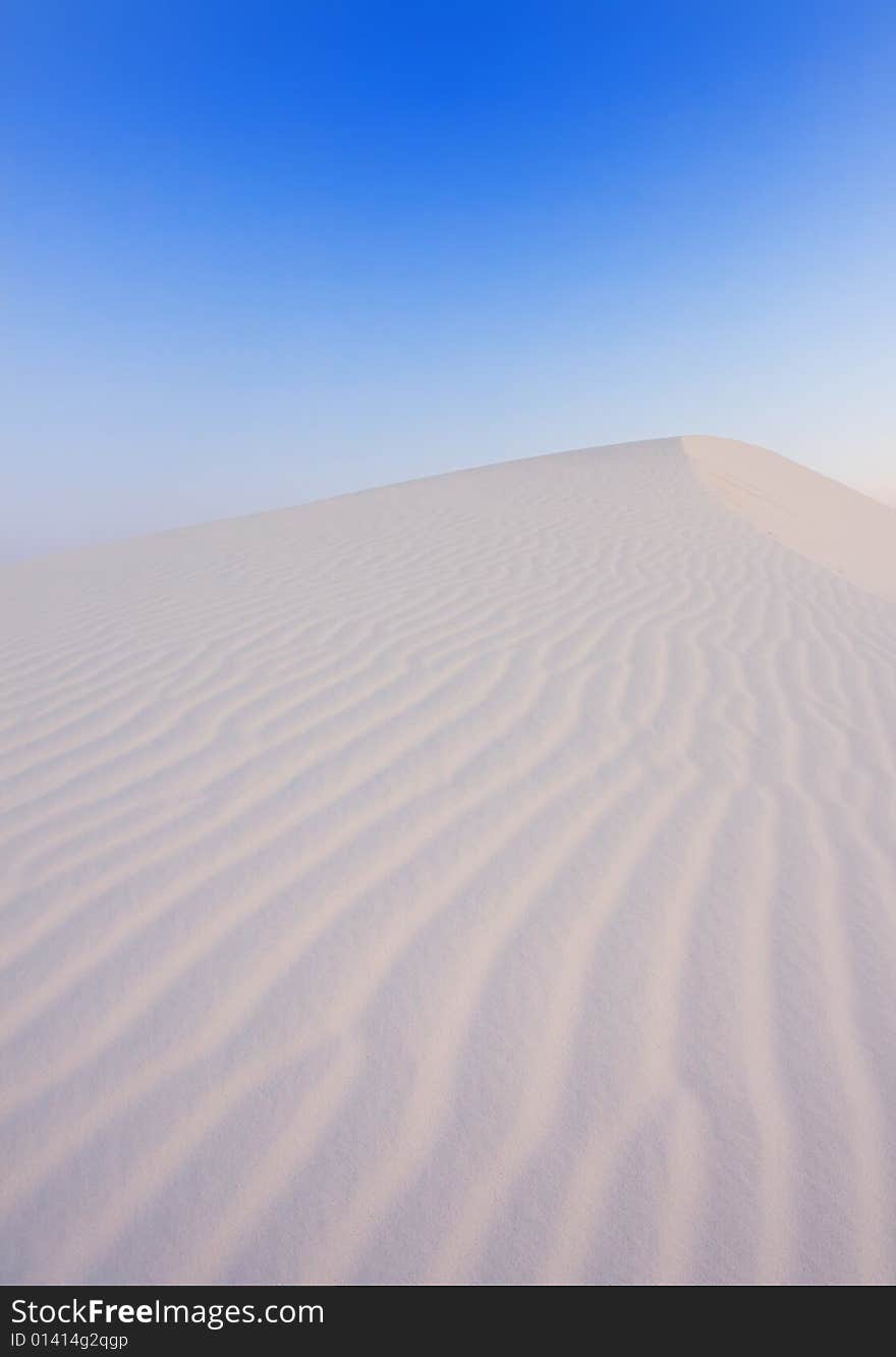 An image of soft sand dunes at dawn. An image of soft sand dunes at dawn