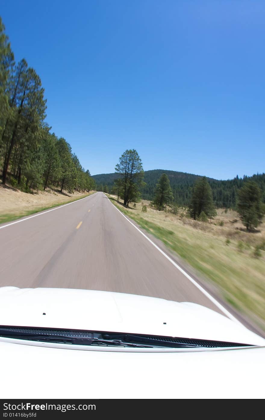 An image of the open road from inside a car. An image of the open road from inside a car