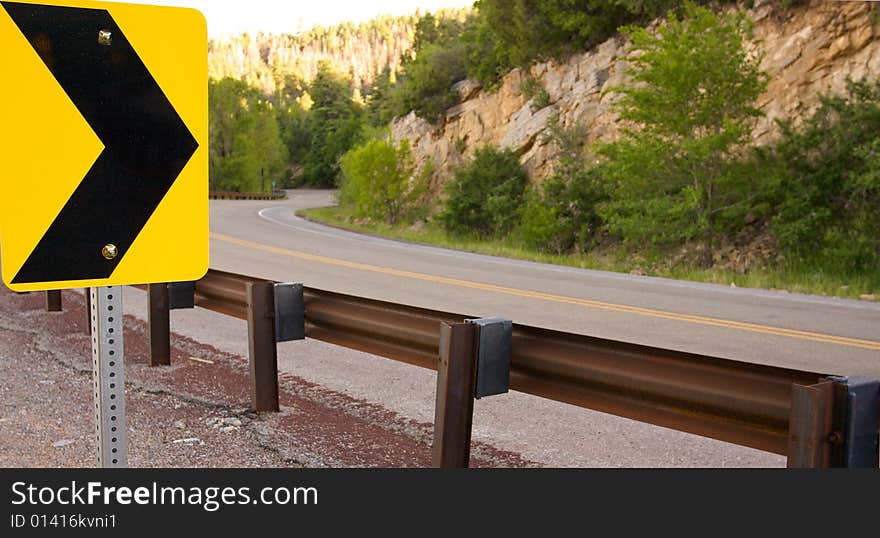 An image of a curve in a mountain road. An image of a curve in a mountain road