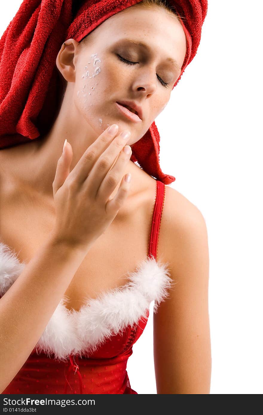 Studio portrait of a beautiful girl who is applying creme to her face. Studio portrait of a beautiful girl who is applying creme to her face