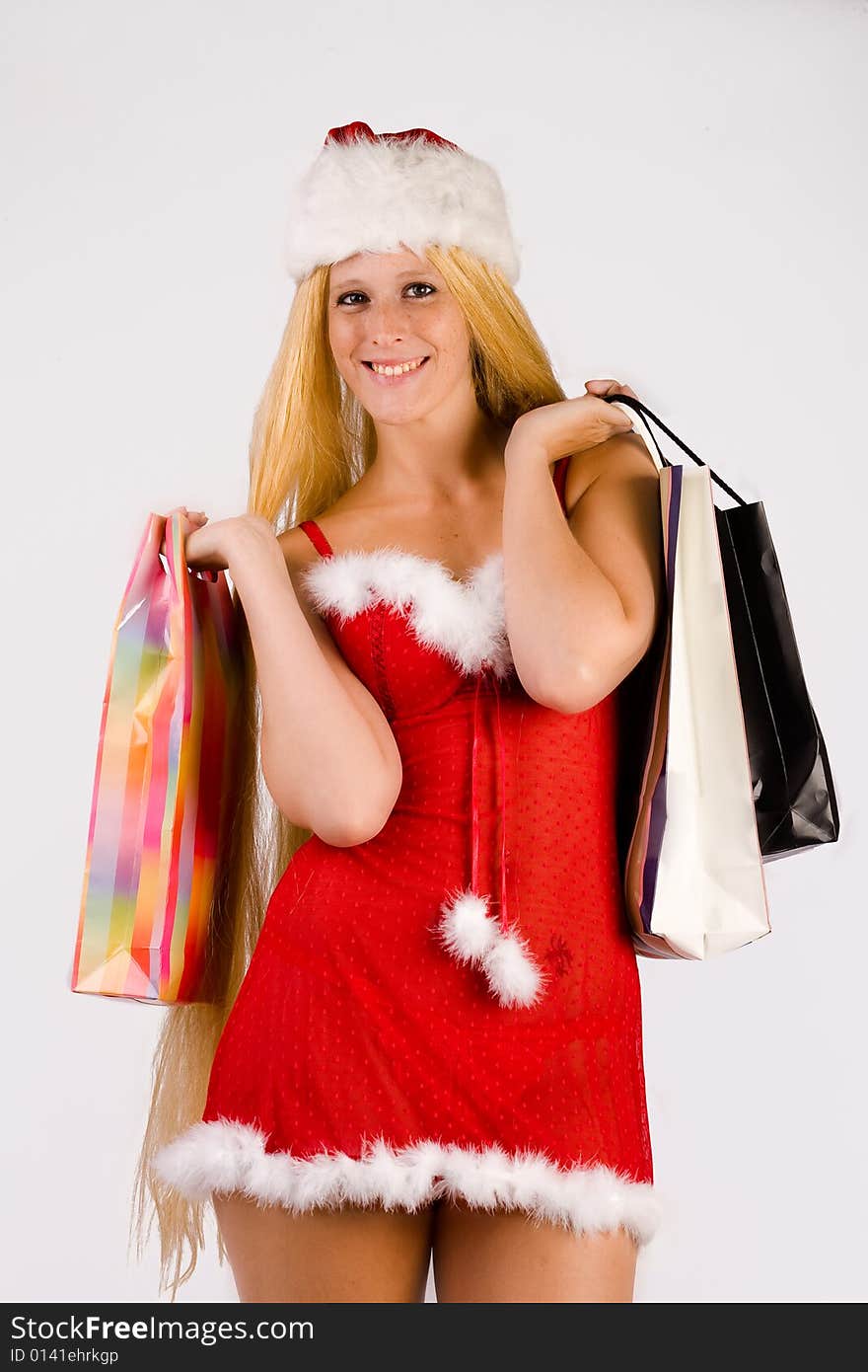 Studio portrait of blond Christmas girl with very long blond hair and shopping bags. Studio portrait of blond Christmas girl with very long blond hair and shopping bags