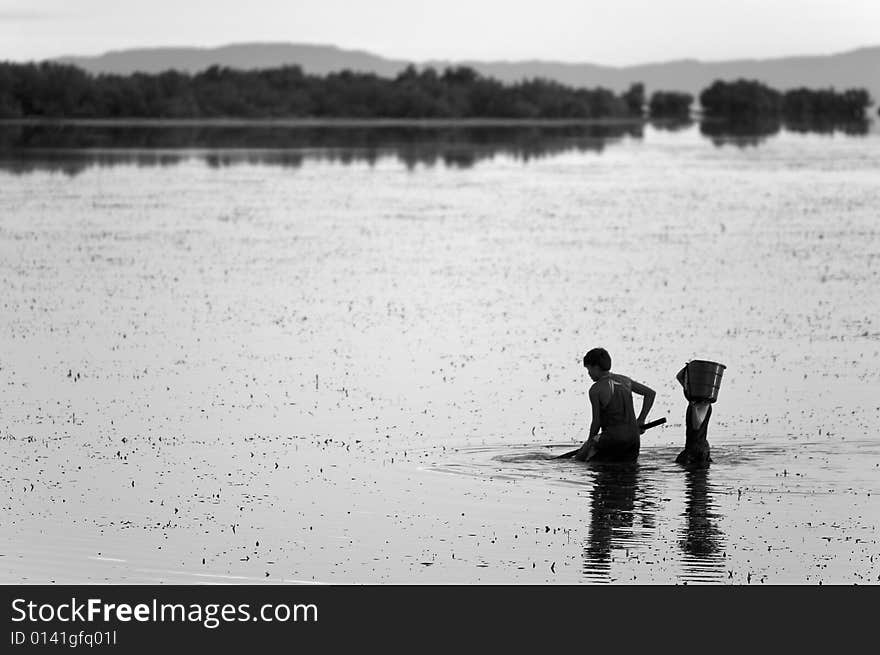 Young kids fishing off the calm sea waters in Day-as, Cordova, Cebu, Philippines. Young kids fishing off the calm sea waters in Day-as, Cordova, Cebu, Philippines.