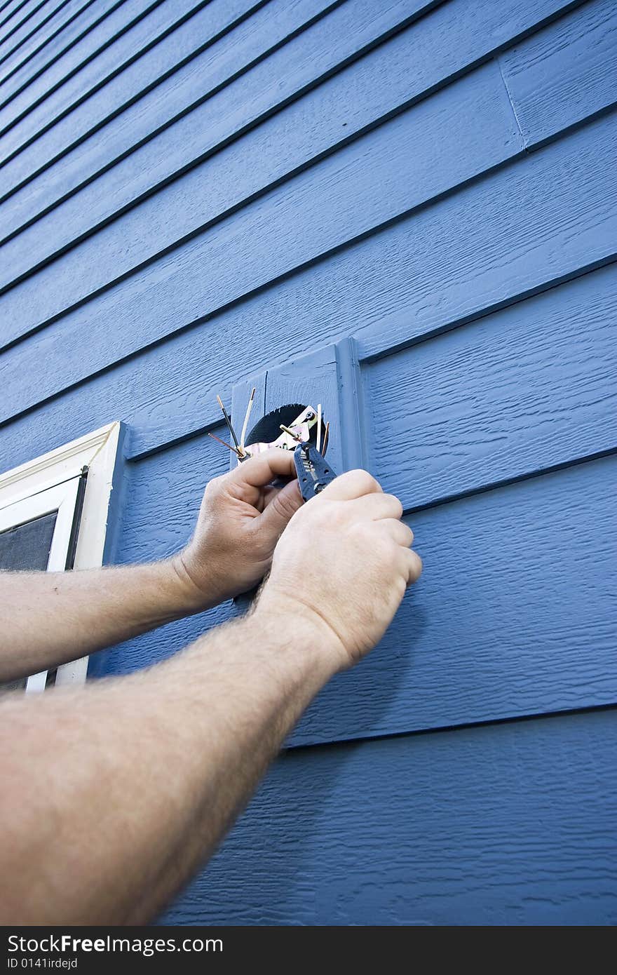 Man Fixing House - Vertical