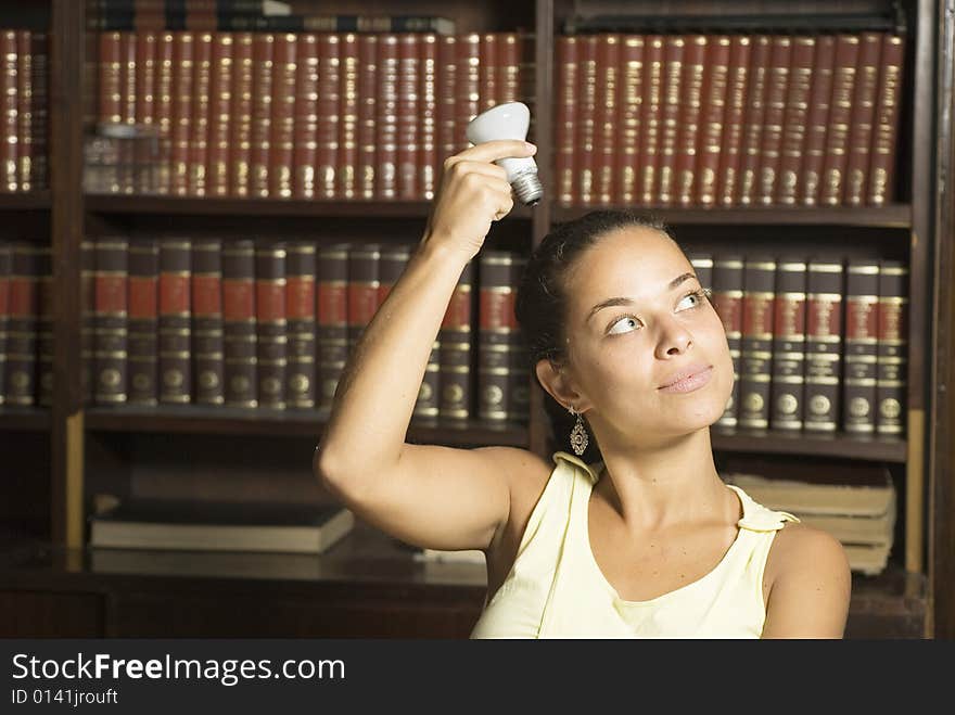 Woman holding light bulb over head. Horizontally framed photo. Woman holding light bulb over head. Horizontally framed photo.