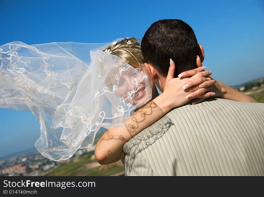 Groom and bride with a flying veil outdoor. Groom and bride with a flying veil outdoor