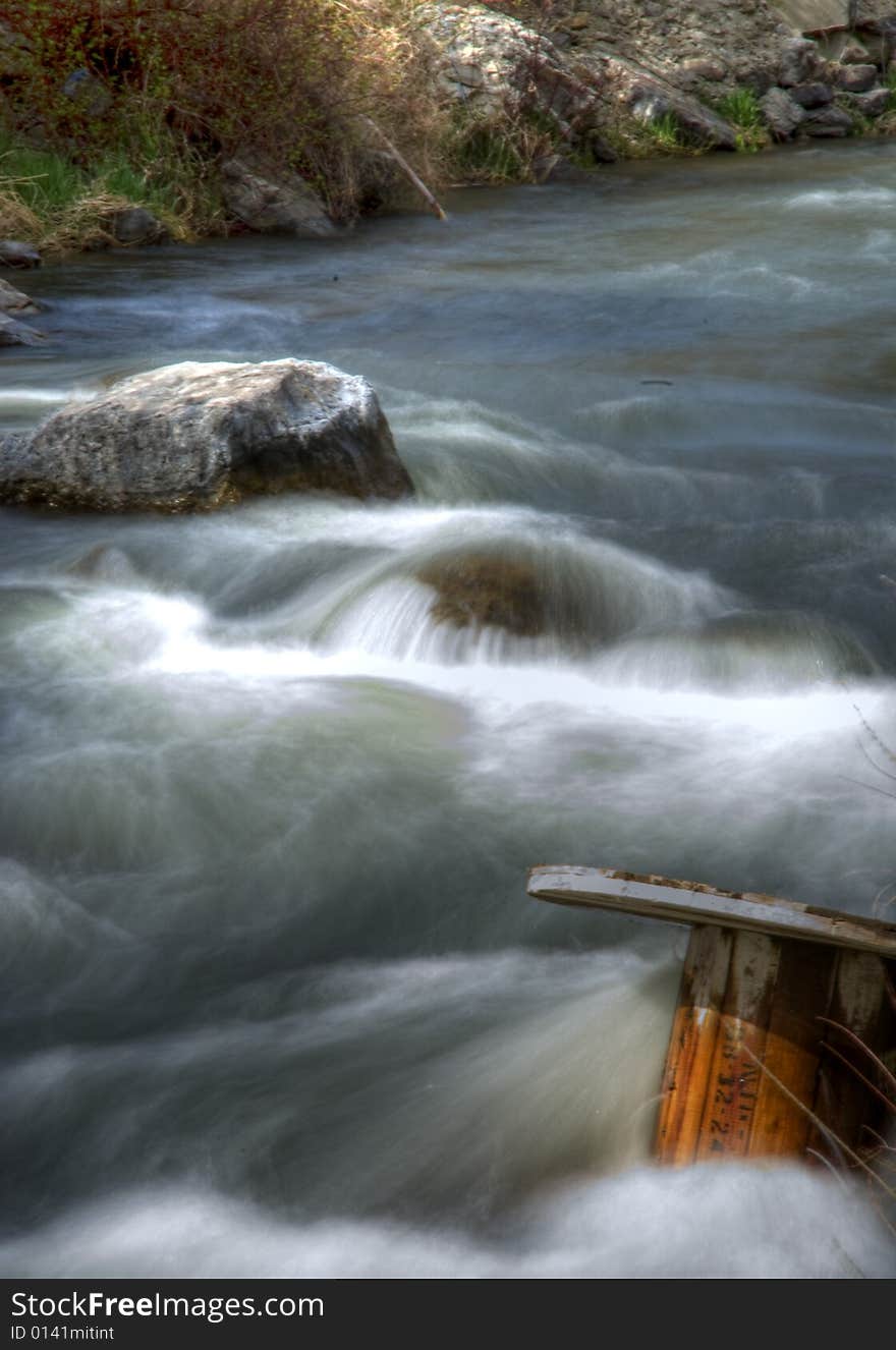 Provo River flowing spedily along with a spool in the water. Provo River flowing spedily along with a spool in the water.