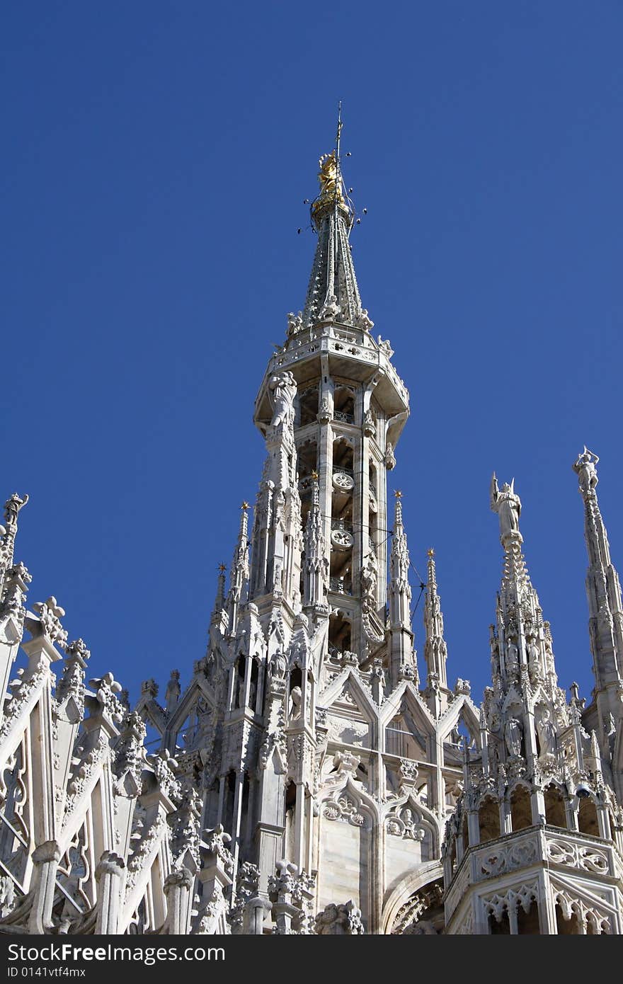 The highest spire of the cathedral of milan with madoninna