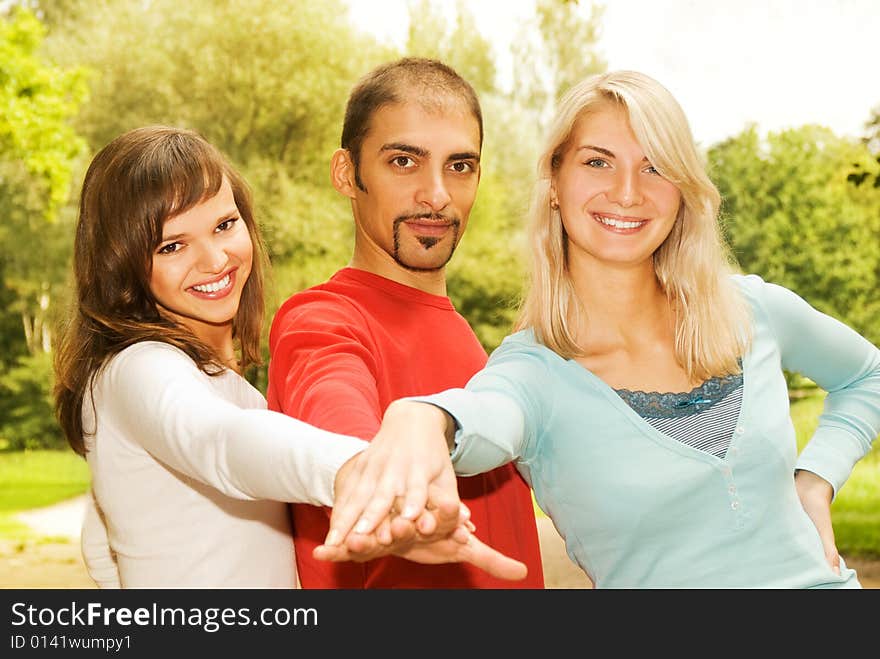 Group of young people put hands on top of each other