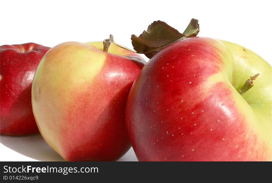 Three ripe apples on a white background