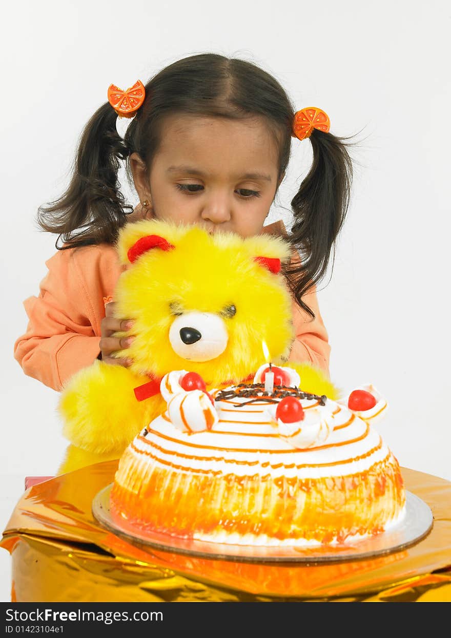 Asian girl celebrating birthday with teddy bear