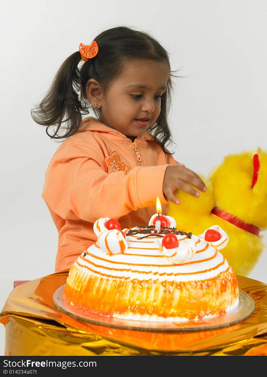 Asian girl celebrating birthday with teddy bear