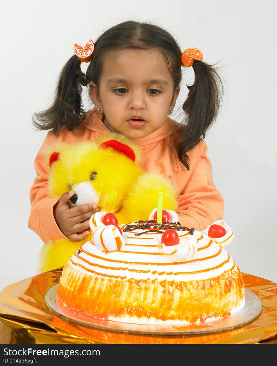 Asian girl celebrating birthday with teddy bear