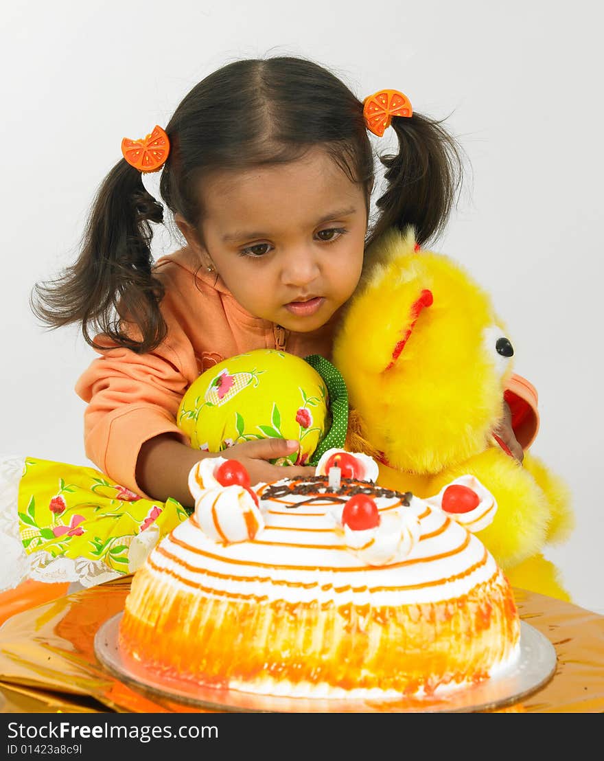 Asian girl celebrating birthday with teddy bear