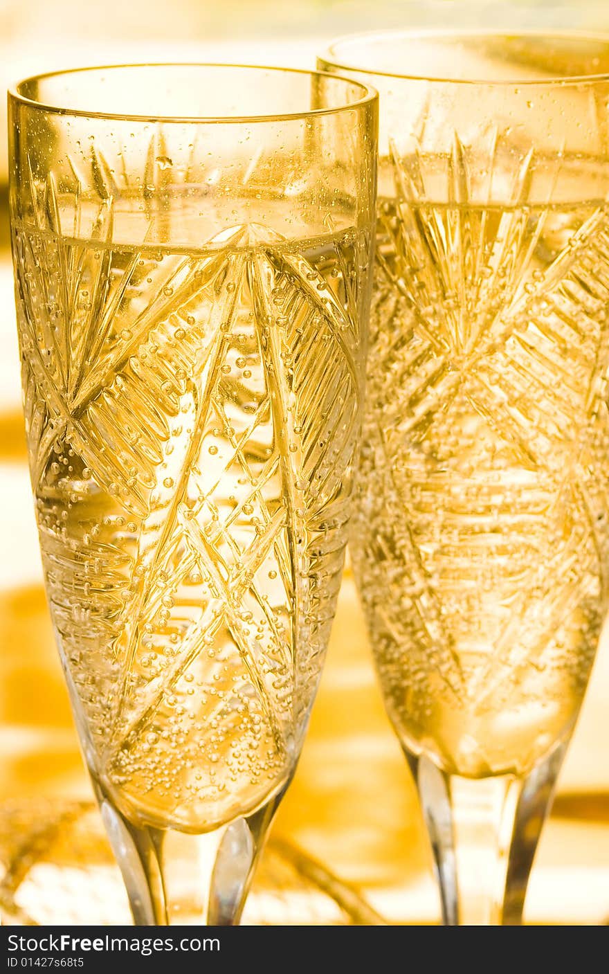 Champagne in glass on yellow background